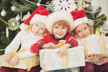 Fototapeta na wymiar three children with gifts