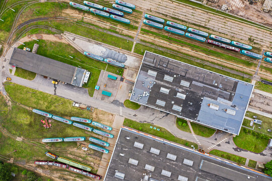 tram depot in city. trams, tramway tracks and industrial buildings. aerial top view from flying drone