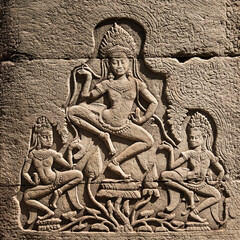 A stone-carved bas-relief depicting dancing apsaras on a column of a Cambodian temple in the Angkor complex