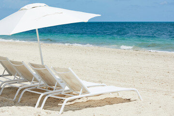 Chairs with umbrellas by the sea, beach chairs