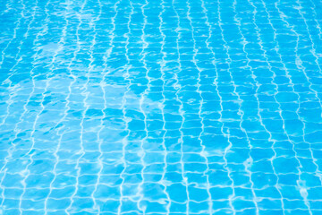 Reflections from the water in the blue swimming pool
