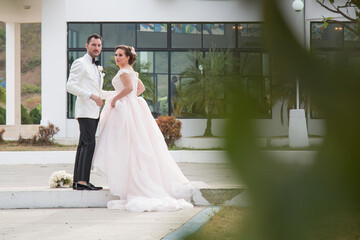 Latino Bride and groom with white tuxedo 