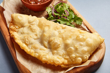 Cheburek with tomato sauce and parsley