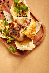 Chicken in dough served on wooden tray