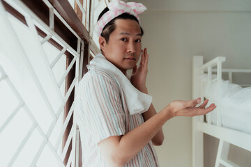 Asian gay apply the facial lotion.