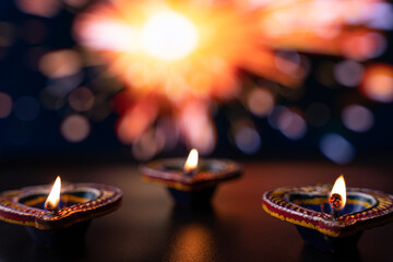 Indian festival Diwali, Diya oil lamps lit on colorful rangoli. Hindu traditional. Happy Deepavali. Copy space for text.