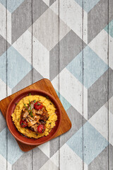 Hummus with beef served in brown bowl