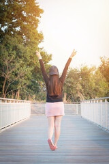 Asian women raise both arms