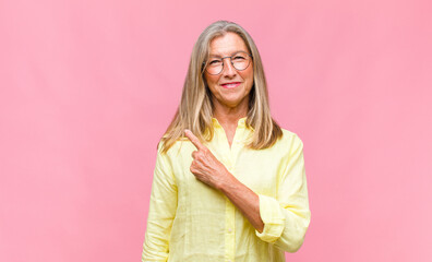 middle age pretty woman smiling and looking friendly, showing number nine or ninth with hand...