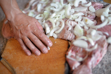 the process of cooking meat with vegetables wrapped in foil, on the grill at home, with your own hands, on an autumn day