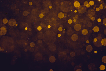 Fantasy gold bokeh sparkle from light on black