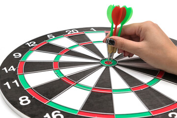 Hands with darts at the target center