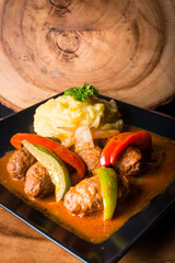 Greek style meat balls cooked with potato, bell peppers and sauce