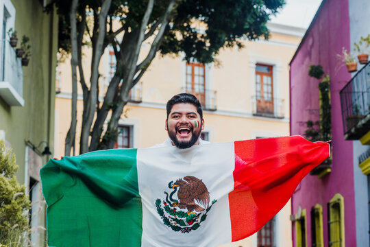 Mexican Man holding a flag of Mexico