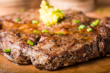 Beef steak served with mashed potato and gravy with melting butter