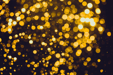 Abstract gold defocused bokeh of lights in dark