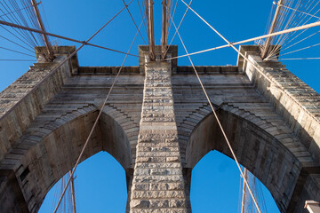 New york city manhattan to brooklyn bridge with use flag on top sand suspension cables