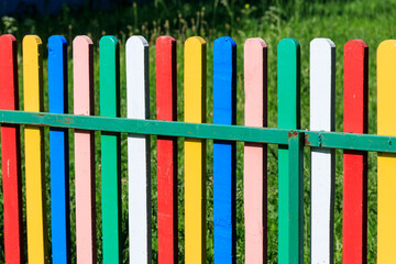 Close-up of the multicolored painted wooden fence