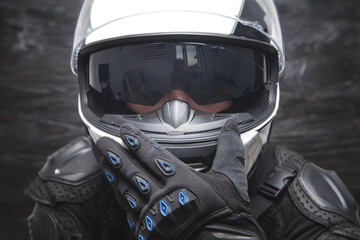 Fototapeta premium Motorbiker wearing stylish helmet and protective gloves.