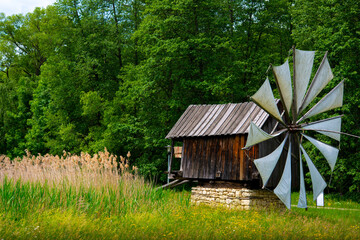 wooden windmill on the plain behind the house