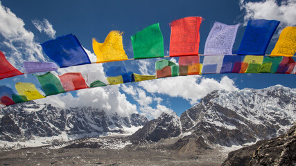 Bright red, blue, green, yellow, white Buddhist prayer flags on a Himalayan mountain. No people