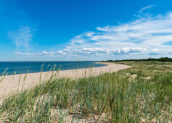 Fototapeta na wymiar traditional summer landscape with sandy and pebbly promontory, blue sea and sky, Harilaid Nature Reserve, Estonia, Baltic Sea