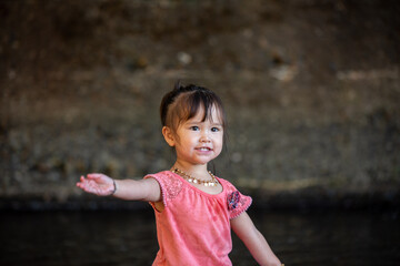 little girl portrait on the river 
drinking water from the river 