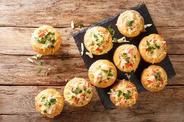 American snack corn muffins stuffed with crab herbs and cheese close-up on a slate board on the table. horizontal top view from above