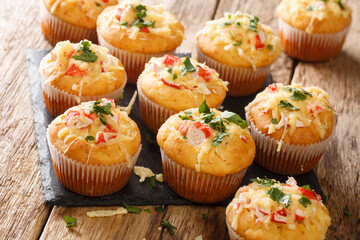 Delicious corn muffins stuffed with seafood herbs and cheese close-up on a slate board on the table. horizontal