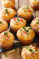 Corn muffins with crab meat and cheese close-up on a slate board on the table. vertical