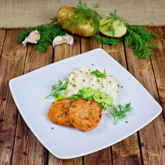 Cutlets with potatoes on a white plate