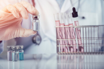 Doctors are showing an antiviral vaccine bottle