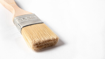 A paint brush on a white background with a place for text to paint walls and objects with paint. Tools for repair.