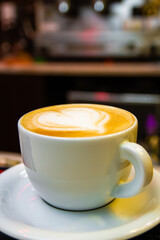 A cup of coffee. Latte with heart pattern in a white cup