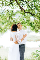 Fototapeta premium Attractive happy couple in love hugging. Man embracing tender woman.