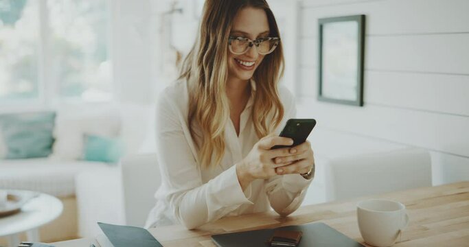 Professional young woman checks her phone while working from home, keeping in touch, remote work concept