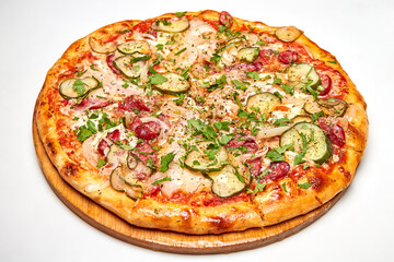 Fresh pizza pickles, bacon, sausages and cheese on a wooden board. Close-up, selective focus