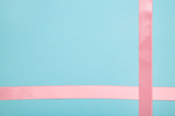Pink ribbon on blue background, design element
