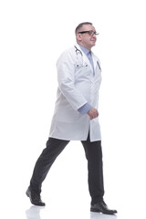 in full growth. confident male doctor striding forward