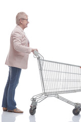 side view. happy adult woman with shopping cart