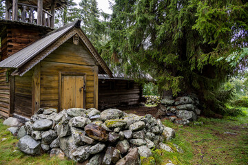 Naklejka premium wooden ancient church on the island among the trees during the rain