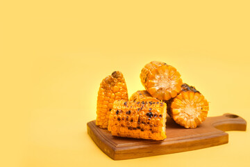 grilled corn on a yellow background, copy space