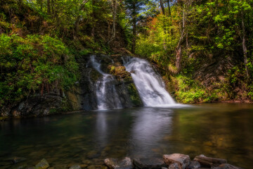 wonderful waterfall on the mountain river Carpathians. Gurkalo or Hurkalo Waterfall, Carpathian Mountains, National Park of Skole Beskydy, Ukraine. June 2020. Long exposure shot.