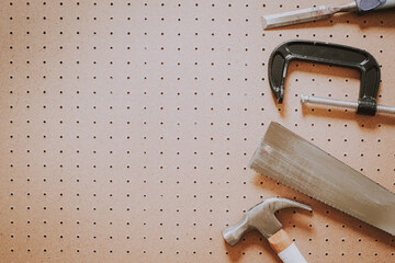 Top view of woodworking tools on pegboard background with copy space