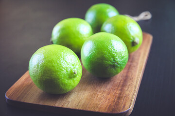 Organic fresh limes on a cutting board