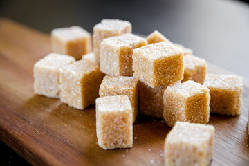 Brown cane sugar cubes on a cutting board