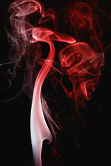 Obraz premium Red smoke on a black background. Colored smoke. Incense stick smoke, illuminated by red light.