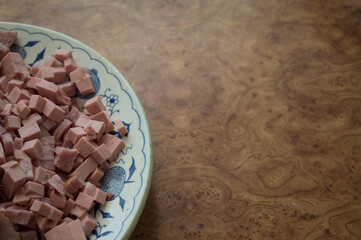 Sliced ​​sausage in a plate on the table.