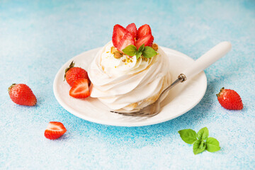 Anna Pavlova cake with cream and strawberries on a plate