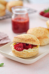 Traditional British Scones with clotted cream, raspberry jam. Scones with raspberry jam